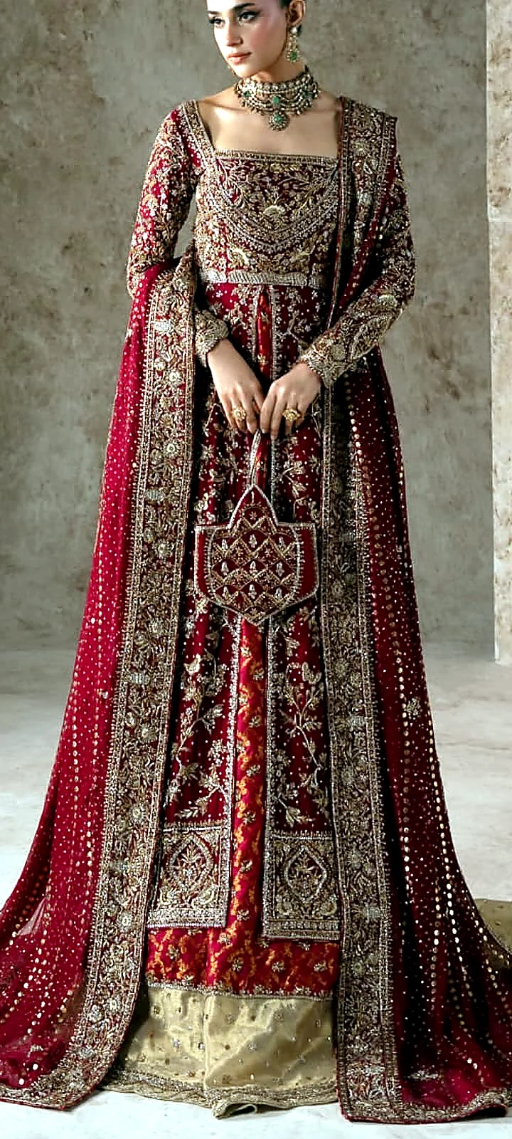 Ruby red bridal farshi dress front view with embroidered potli bag